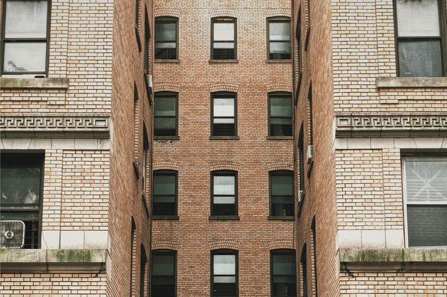 stock image of a light brown brick exterior of an apartment building